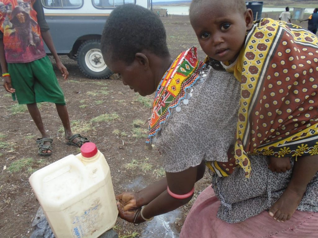 in El Molo Kenya A woman washes her hands after visiting town to protect herself against COVID-19