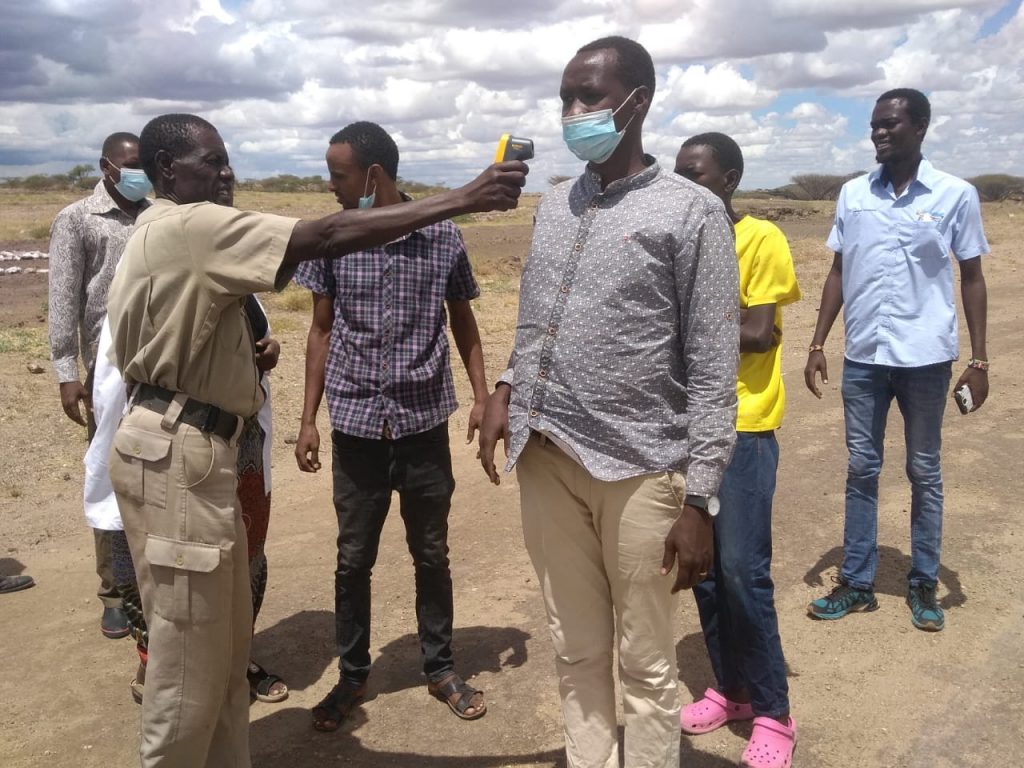 on the El-Molo border community organises screening to monitor fever and illness of those who enter village