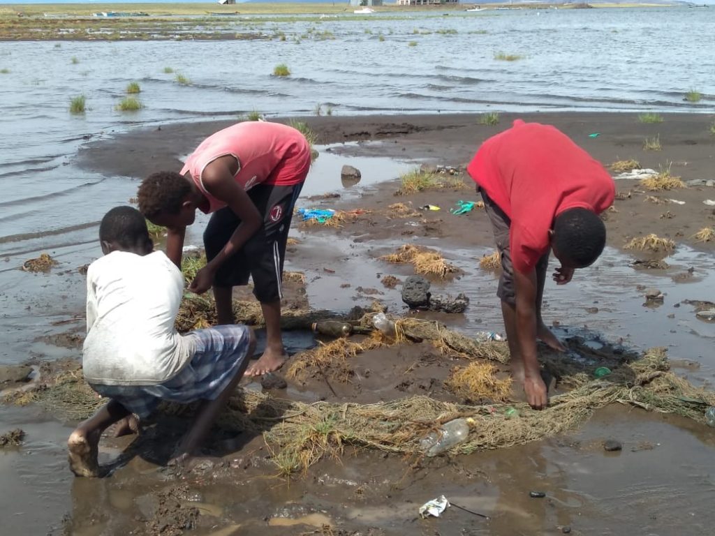 El Molo, Kenya young boys fishing for fingerlings to use as bait in Lake Turkana